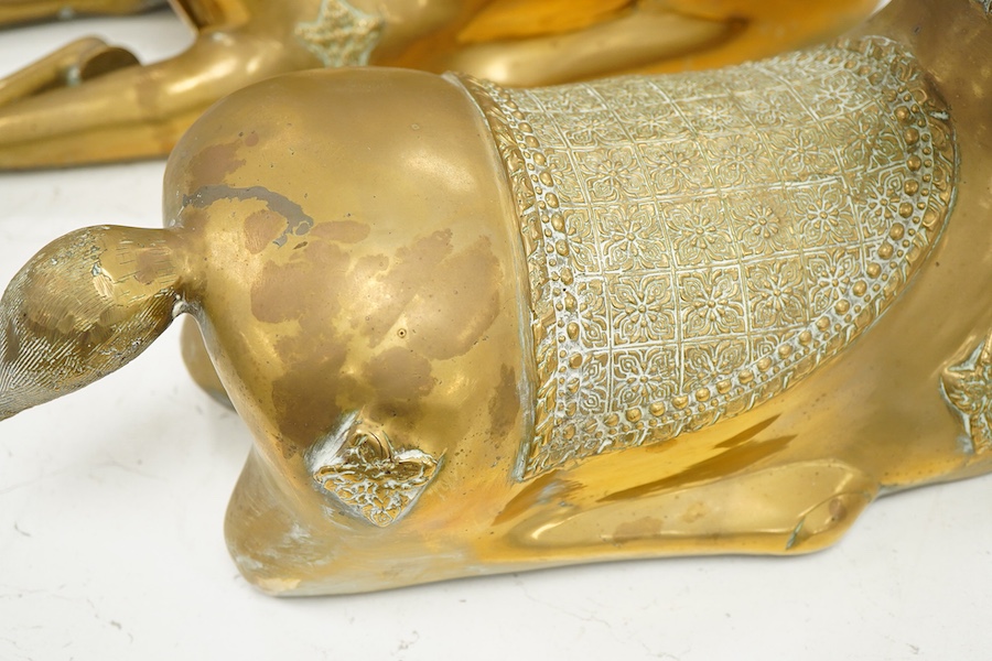 A pair of modern Chinese polished bronze 'Feng Shui' models of antlered recumbent deer with decorated bodies, height 66cm